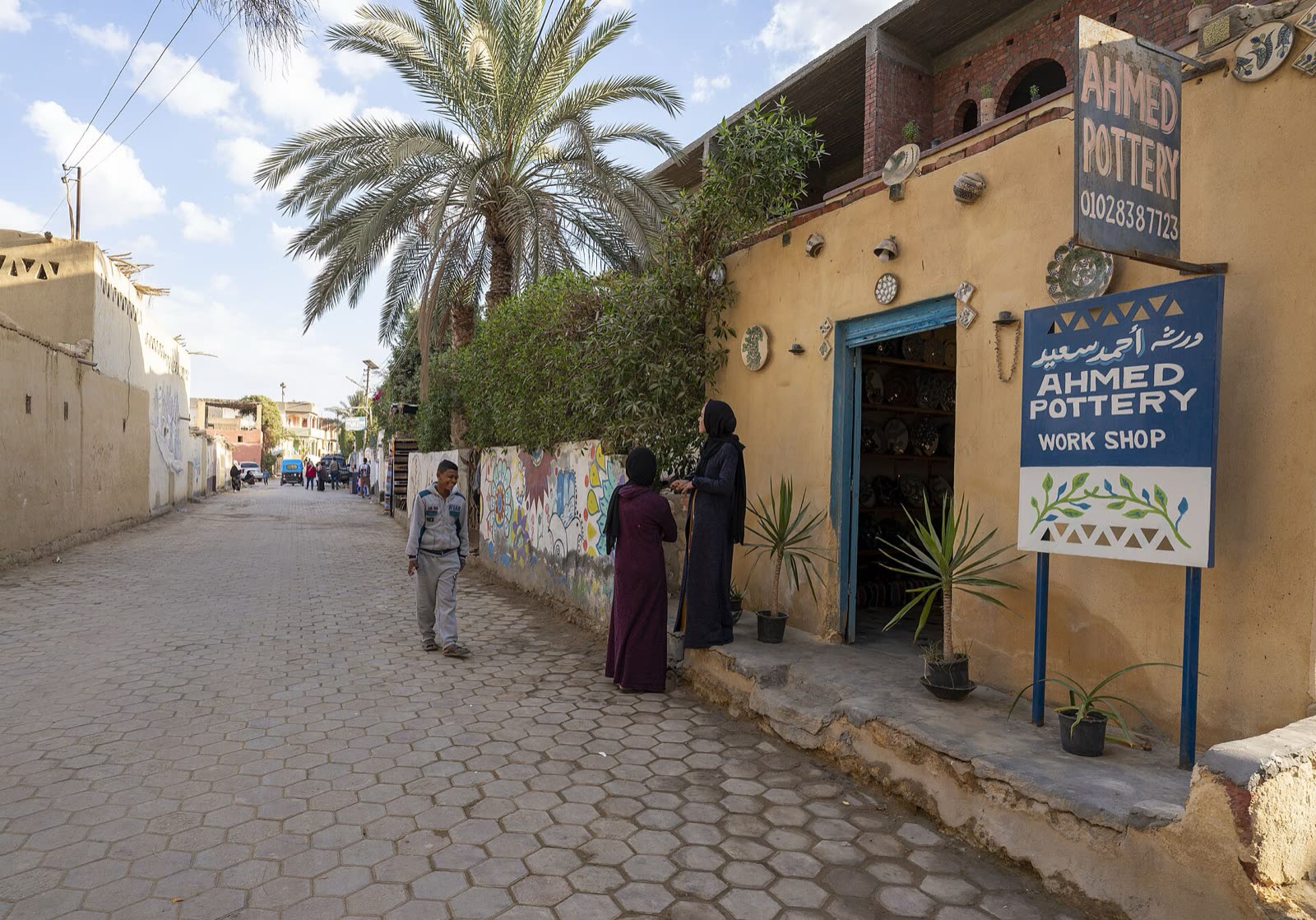 Shelves, vessels and work area inside Ahmed Saeed Pottery Workshop in Tunis village, Fayoum